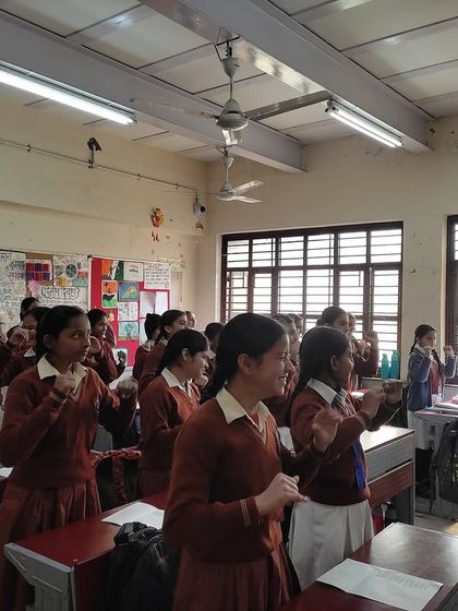 A classroom of girls sings with open hearts and joyful expressions. This image perfectly captures the feeling of freedom and self-expression that our music sessions inspire.