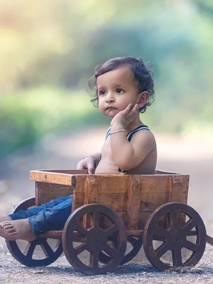 Capturing the quiet, pensive moments is just as important as the smiles. This candid portrait reveals a glimpse into his little world.