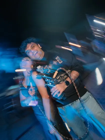 A fun, blurry shot of the couple enjoying a hookah at their party. This captures the wild, carefree vibe of the night.