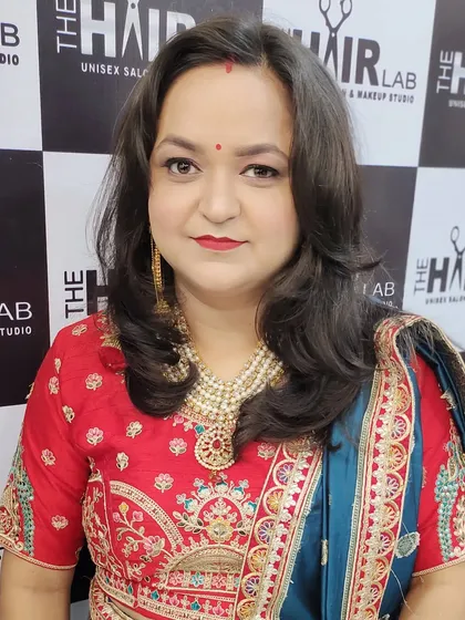 This client is glowing and ready for the party. I gave her soft, face-framing hair layers and makeup that highlights her features, paired with her embroidered outfit.