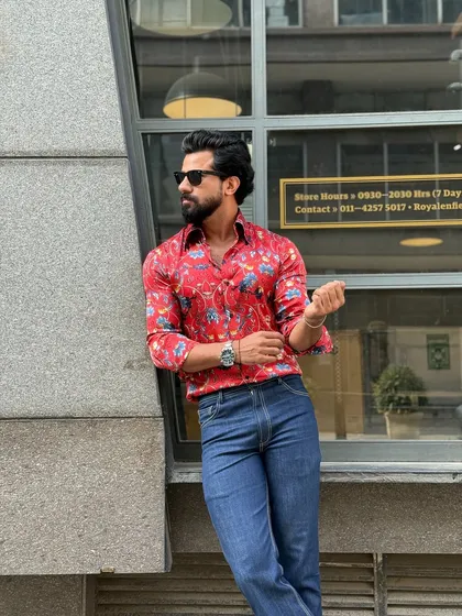 A relaxed pose against an urban backdrop, this image showcases the shirt's eye-catching design and comfortable fit.