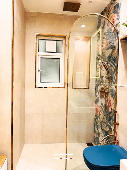 This bathroom design combines bold aesthetics with luxurious functionality. I used a vibrant floral tile pattern as a feature in the shower, complemented by gold-finished fixtures and an arched glass door to create a space that feels both artistic and refreshing.