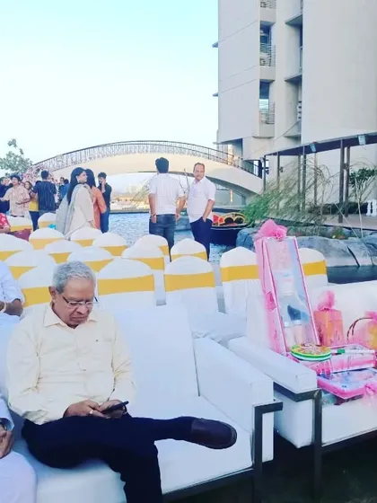 A mix of seating options at an outdoor event, including comfortable white sofas for family members and rows of chairs for other guests, ensuring everyone has a place to relax.