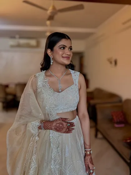 A sleek and polished open hairstyle for a wedding guest. The hair is styled with a side part and gentle waves at the ends for a sophisticated finish.