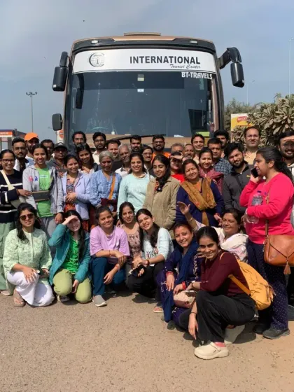 Our entire travel group posing in front of our bus before heading to the Kumbh grounds. We travel as a community, supporting each other on this incredible journey.