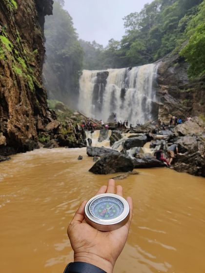 A compass pointing towards Sathodi Falls, symbolizing our spirit of exploration and adventure on our Yallapura trips.