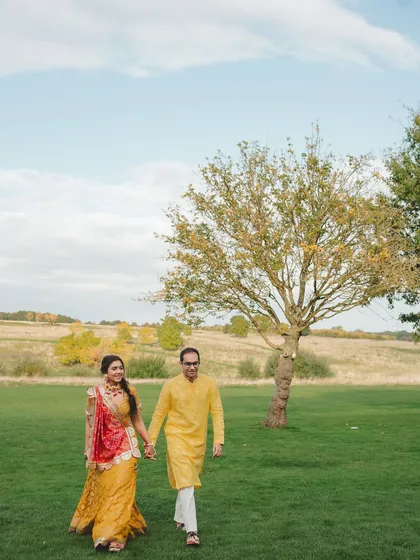 The couple taking a walk in the vast green fields of the English countryside. We help you choose venues that offer stunning natural landscapes for your photos and events.