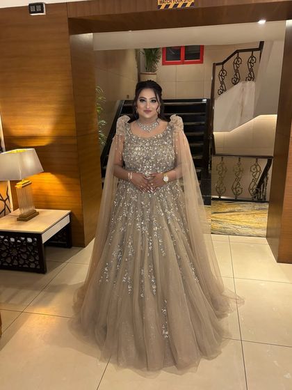 A full-length shot showing the magnificent gown and the glamorous makeup. She looks like she stepped right out of a fairytale, ready for her reception.