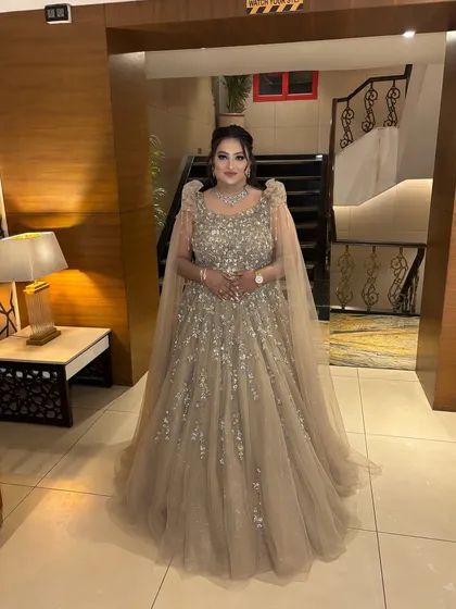 A full-length shot showing the magnificent gown and the glamorous makeup. She looks like she stepped right out of a fairytale, ready for her reception.