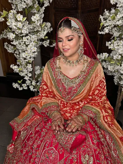 A candid moment showing the bride's beautiful smile and the flawless finish of her HD makeup.