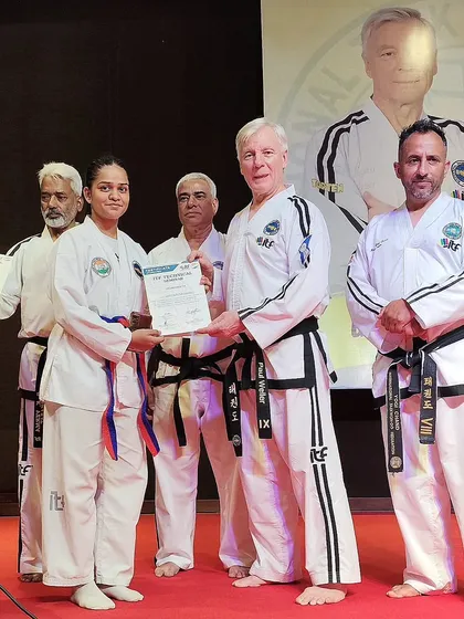 One of our students, Shivani Gupta, receives her certificate for completing the ITF Technical Course from ITF President Grandmaster Paul Weiler.