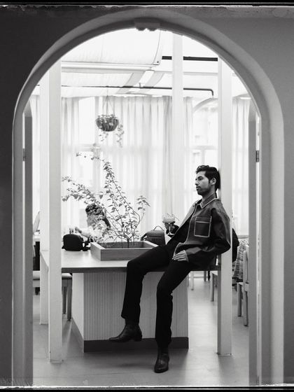 Isshaan, framed by a series of archways. The architecture creates a wonderful sense of depth and perspective in this black and white shot.