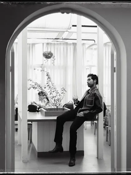 Isshaan, framed by a series of archways. The architecture creates a wonderful sense of depth and perspective in this black and white shot.