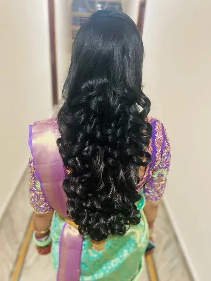 The back view of the long, flowing curls, a perfect hairstyle for a glamorous evening look.