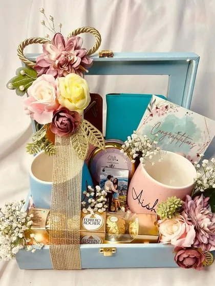 Celebrating love stories is a joy, and this engagement hamper is designed to do just that. It includes personalized "Mr" and "Mrs" mugs, matching passport covers for future adventures, and a photo candle to light up their new journey.