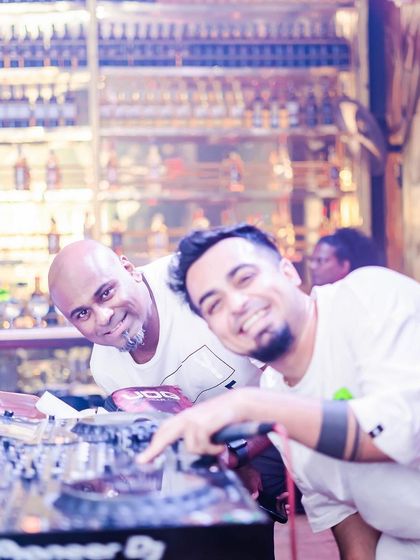 Posing with DJ Milan against the backdrop of the bar.