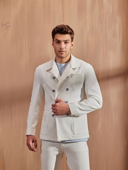 A full-body look at the white denim double-breasted shacket, demonstrating its power to create a sophisticated and contemporary monochrome outfit.