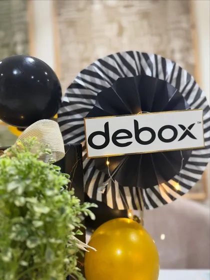 We incorporate your brand identity directly into the gift. Here, the company's logo is featured on a custom decorative fan, making the hamper a true representation of the brand it celebrates.