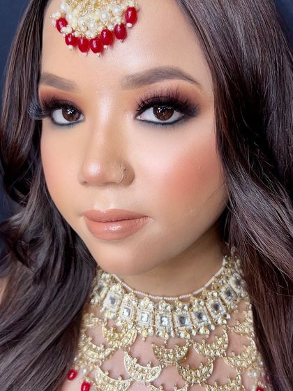 A classic bridal eye makeup look with a brown smokey eye, black kohl, and voluminous lashes.