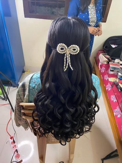 A behind-the-scenes shot of the reception hairdo, showing the volume and definition of the curls before the final touches.