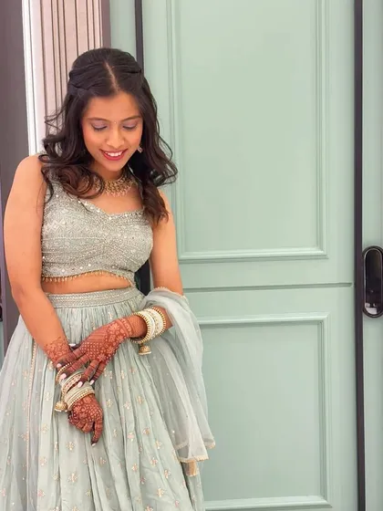A candid shot showing off the soft curls and the delicate details of her outfit.