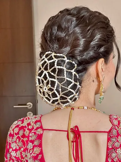 A side view of the textured bun with the pearl net. This hairstyle is a work of art and is perfect for a bride who wants a truly memorable wedding day look.