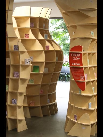 A view of the 'Stradata' installation being assembled on-site. The parametric design was produced in a factory and rapidly deployed, showcasing how digital tools can streamline the creation of complex architectural forms.