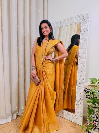 A still shot of the beautiful mustard yellow tissue saree. The fabric has a lovely texture and shine, making it look much more expensive than it is.