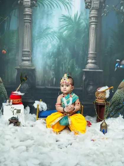 A wider view of the Krishna setup, featuring majestic pillars, peacock props, and a 'dahi handi', creating a mythical forest scene right in my Vashi studio.