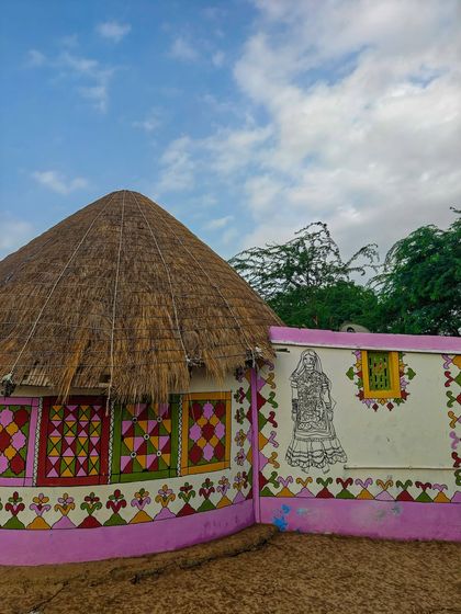A beautifully painted Bhunga, the traditional circular mud hut of the Kutch region. The colorful geometric patterns and murals are a hallmark of Meghwal art and culture.