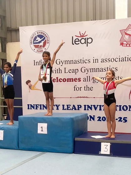 Our gymnasts celebrating their wins together on the podium. Their success is a reflection of their hard work and our academy's training.