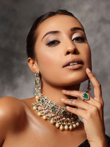 A close-up of a model with a sleek bun, showcasing a clean and glamorous look.