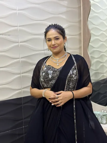 Another shot of the client in her party-ready look. The sleek ponytail keeps the focus on her embellished blouse and diamond jewelry.