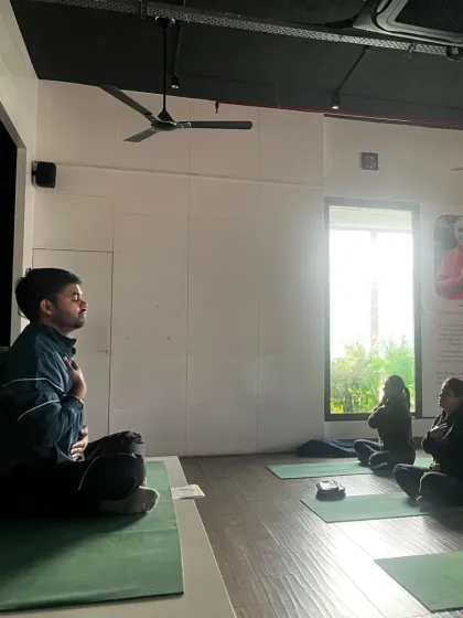 A student finds a moment of quiet reflection during a class in our studio. We create a serene and supportive atmosphere for you to connect with your breath and find your center.