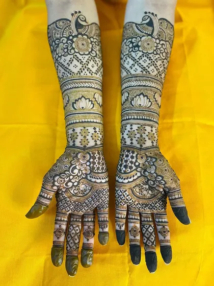 This is an example of a classic bridal design that combines traditional motifs like peacocks and lotuses with clean, geometric patterns for a balanced and elegant look.
