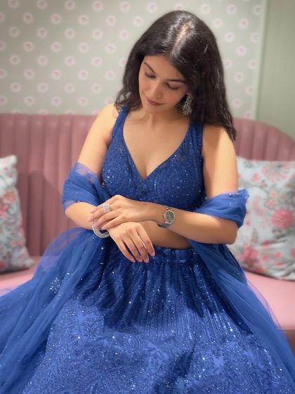 Accessorizing is key. Here, I'm showing how a simple watch and ring can complement a heavy lehenga without overpowering it. It's all about creating a balanced look.