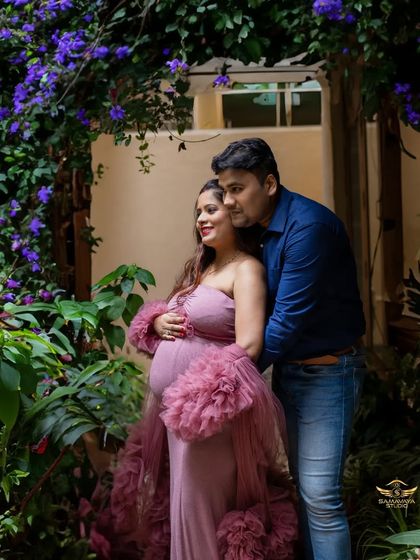An intimate couple's portrait amidst purple flowers in a studio setting. This shows how I can create a lush, outdoor feel indoors.