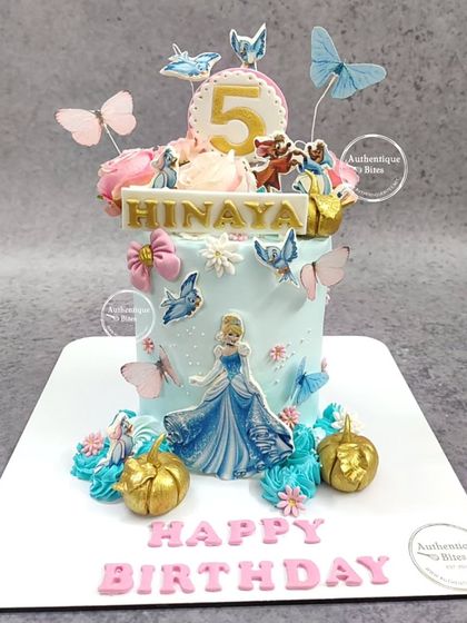 A magical Cinderella cake for a 5th birthday. The design features Cinderella, her pumpkin carriage, and beautiful butterflies, creating a scene straight from the storybook.