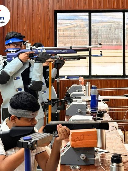 Two of our students in full gear, one aiming a Walther rifle and the other preparing his shot. This close up shows the professional equipment and serious focus of our trainees.