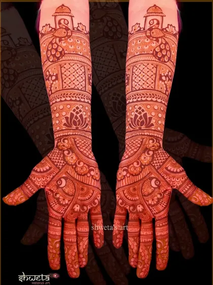 This design features stunning peacock motifs at the top of the arm, with intricate patterns flowing down to the palms. The rich red stain shows the quality of my natural henna.