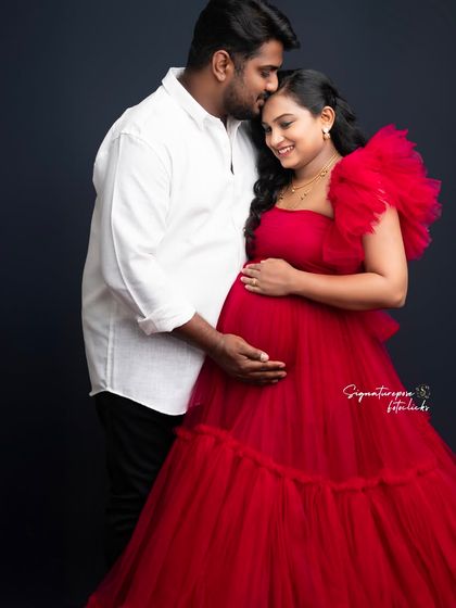 A tender moment between the couple, with the rich red of the gown adding a touch of romance and passion to the portrait.