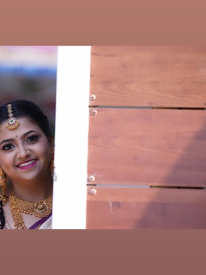 A playful peek-a-boo shot of the bride. Her smile shows how happy and confident she felt with her final bridal look.
