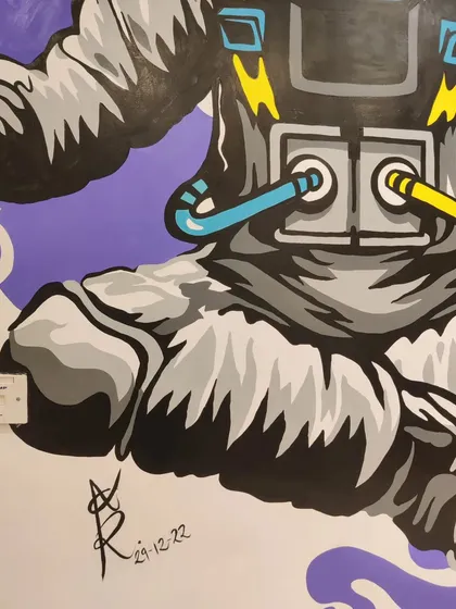 A look at the lower half of the astronaut mural, including my signature. This custom wall painting for an educational space shows how art can make any environment more dynamic.