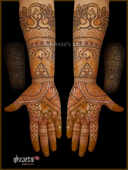 A simple yet elegant bridal henna design. This pattern uses peacock and elephant motifs within a clean, structured layout, ideal for a bride who prefers a less dense look.