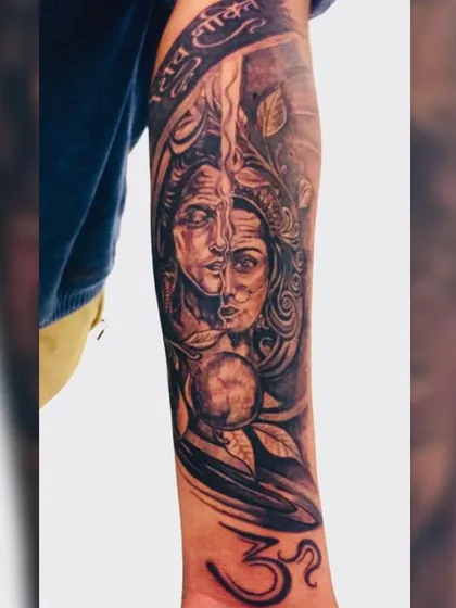 This full forearm sleeve features the Ardhanarishvara, representing the divine union of Shiva and Parvati. We designed this piece to flow with the arm's anatomy, incorporating elements like the Om symbol and 'Jai Shiv Shakti' script. It's a powerful piece of spiritual art that tells a story.