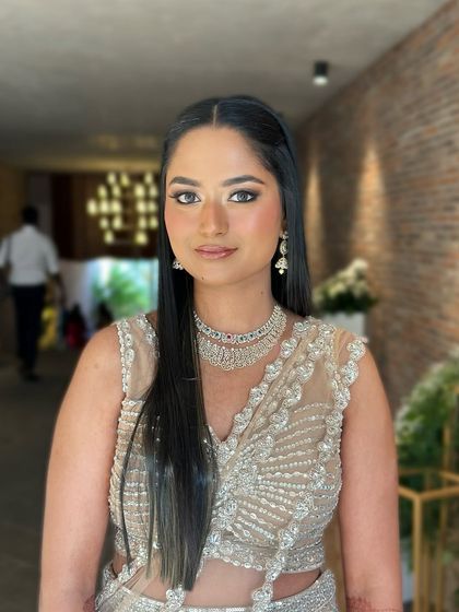 A direct, forward-facing portrait, her makeup looking polished and beautiful.