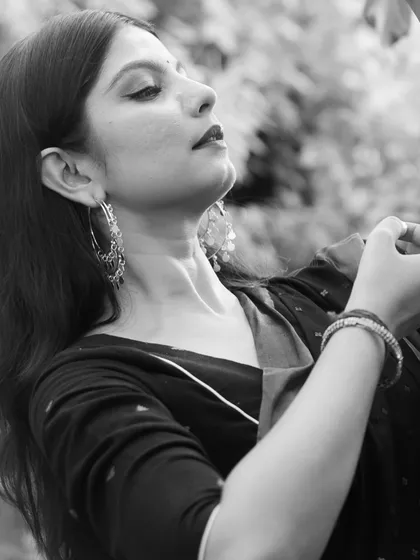 A black and white profile shot, highlighting the graceful lines of the neck and the serene expression.