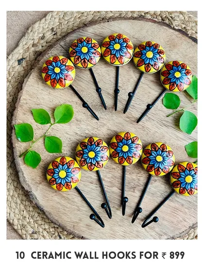 Another design of our new mini ceramic wall hooks. This set of 10 features a beautiful yellow and blue floral pattern, hand-painted by local artisans to add a unique touch to your walls.