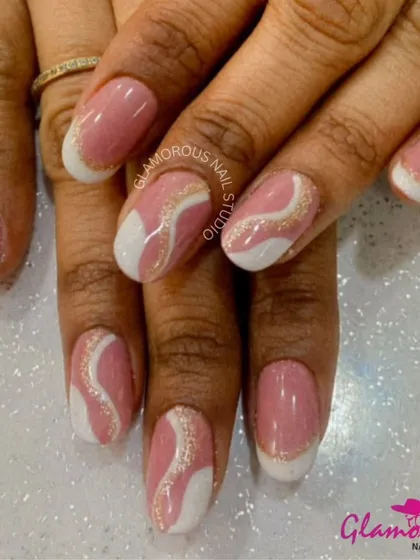 A delicate and feminine design, this set features a soft pink base with abstract swirls of white and sparkling gold glitter.