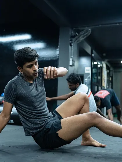 A student practices his ground mobility, essential for Jiu-Jitsu.
